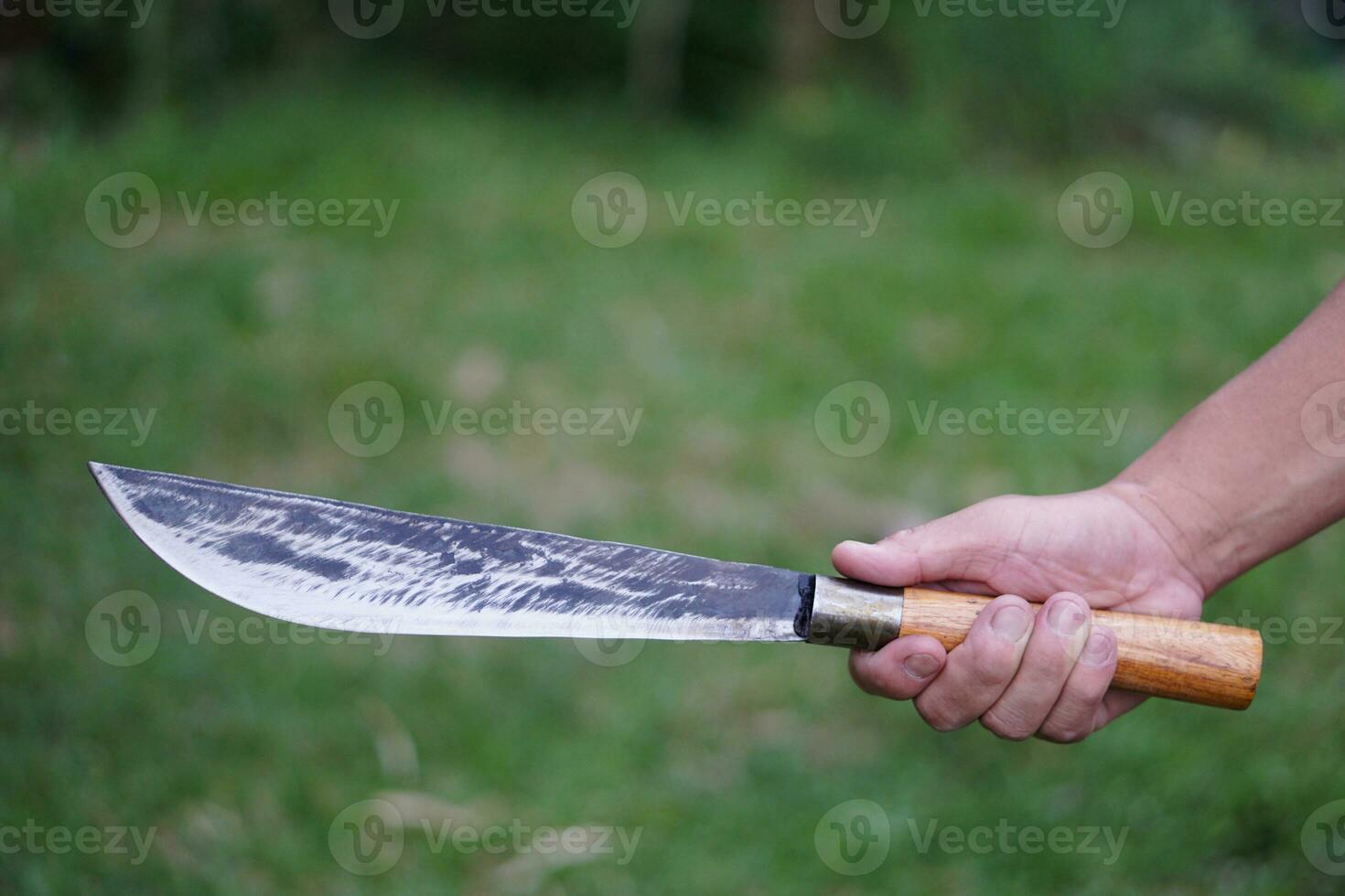 Closeup hand holds vintage knife . Concept ,Tool or equipment in kitchen, use for chopping, cutting when cooking or other purposes as weapon, hunting. knives in local kitchen photo