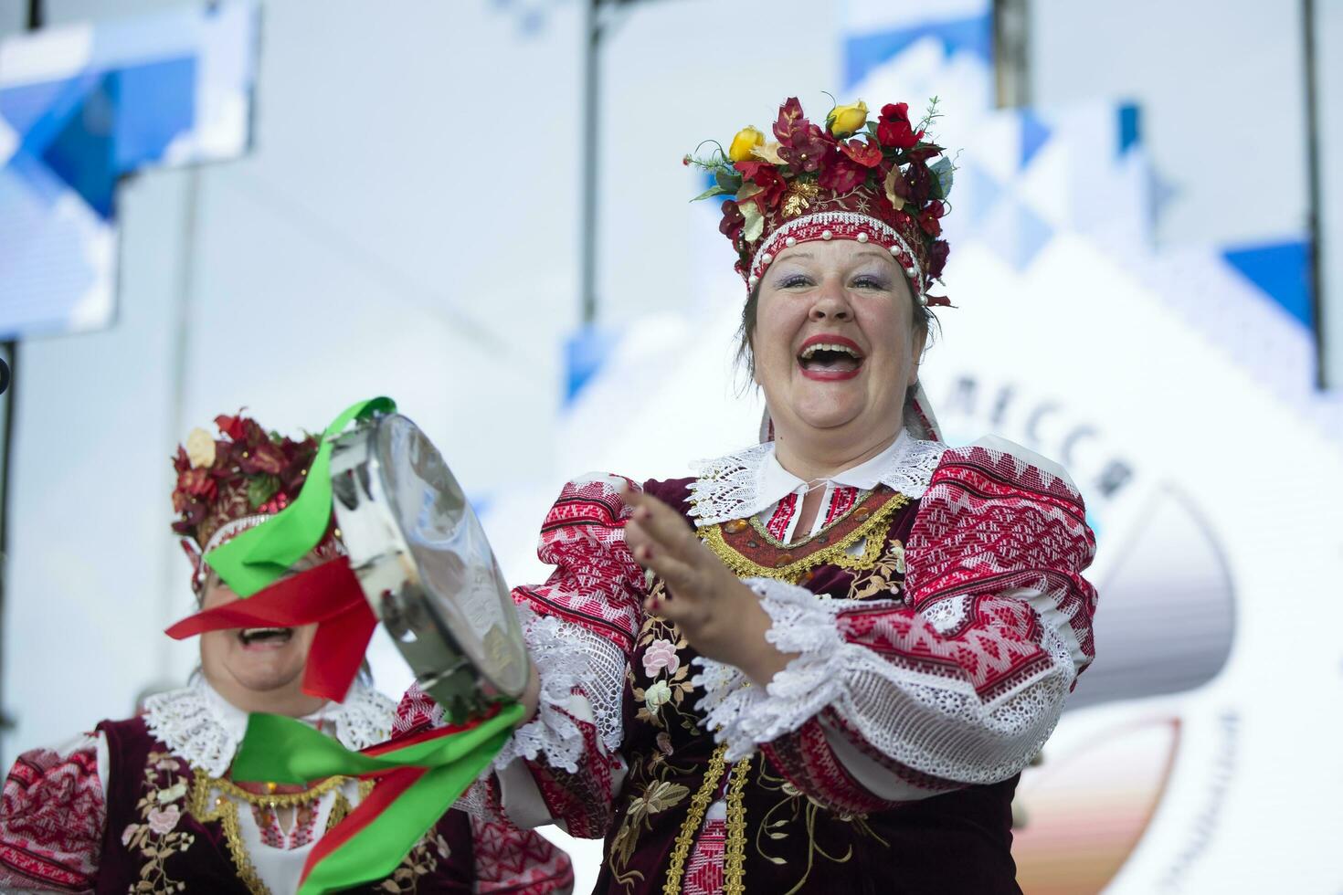 08 29 2020 Belarus, Lyaskovichi. Celebration in the city. An elderly woman in national Slavic clothes sings. photo