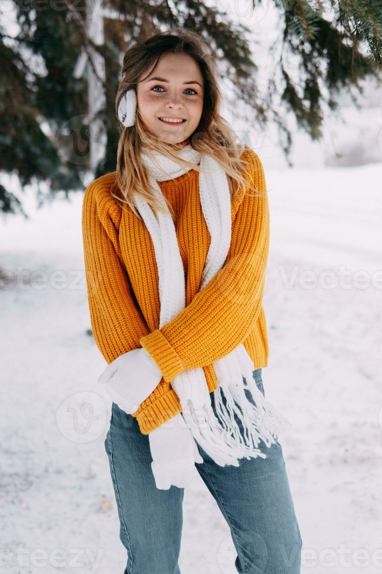 Teen blonde in a yellow sweater outside in winter. A teenage girl on a walk  in winter clothes in a snowy forest 23581436 Stock Photo at Vecteezy