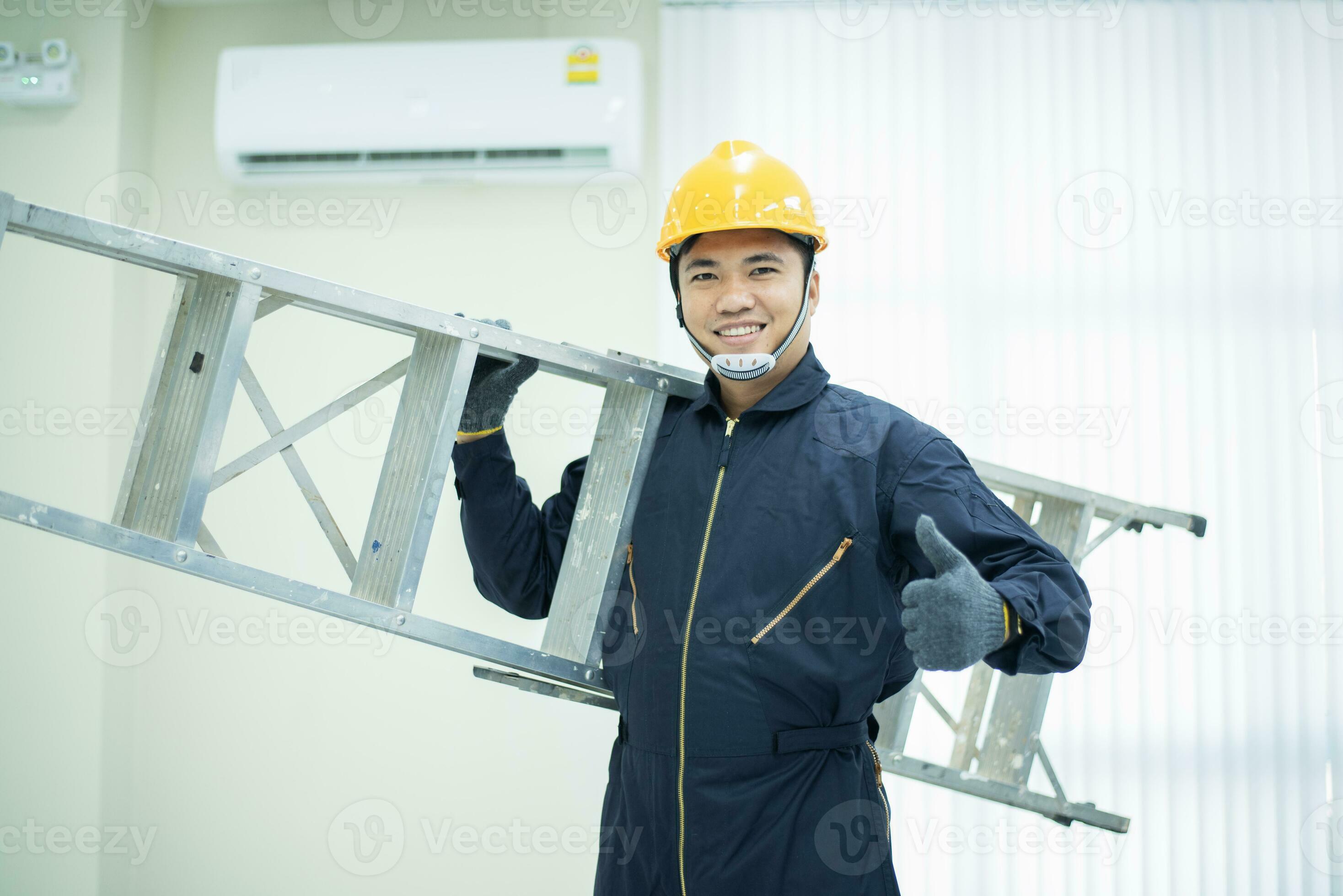 An Asian young Technician service man wearing blue uniform checking