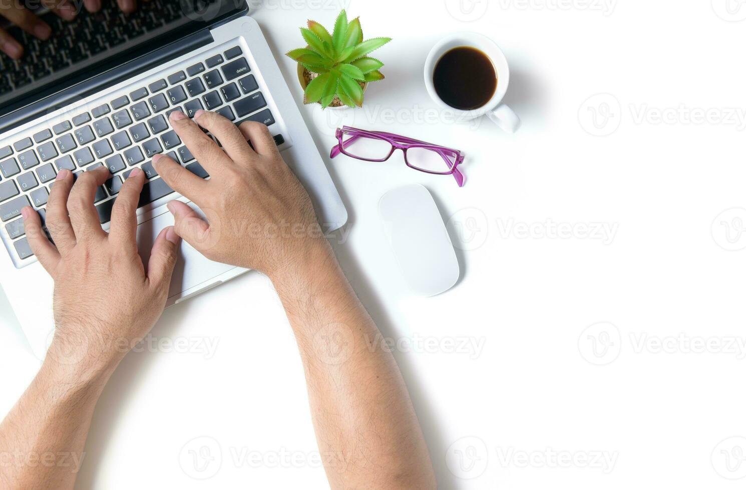 White office desk table with hand man tpying laptop. photo