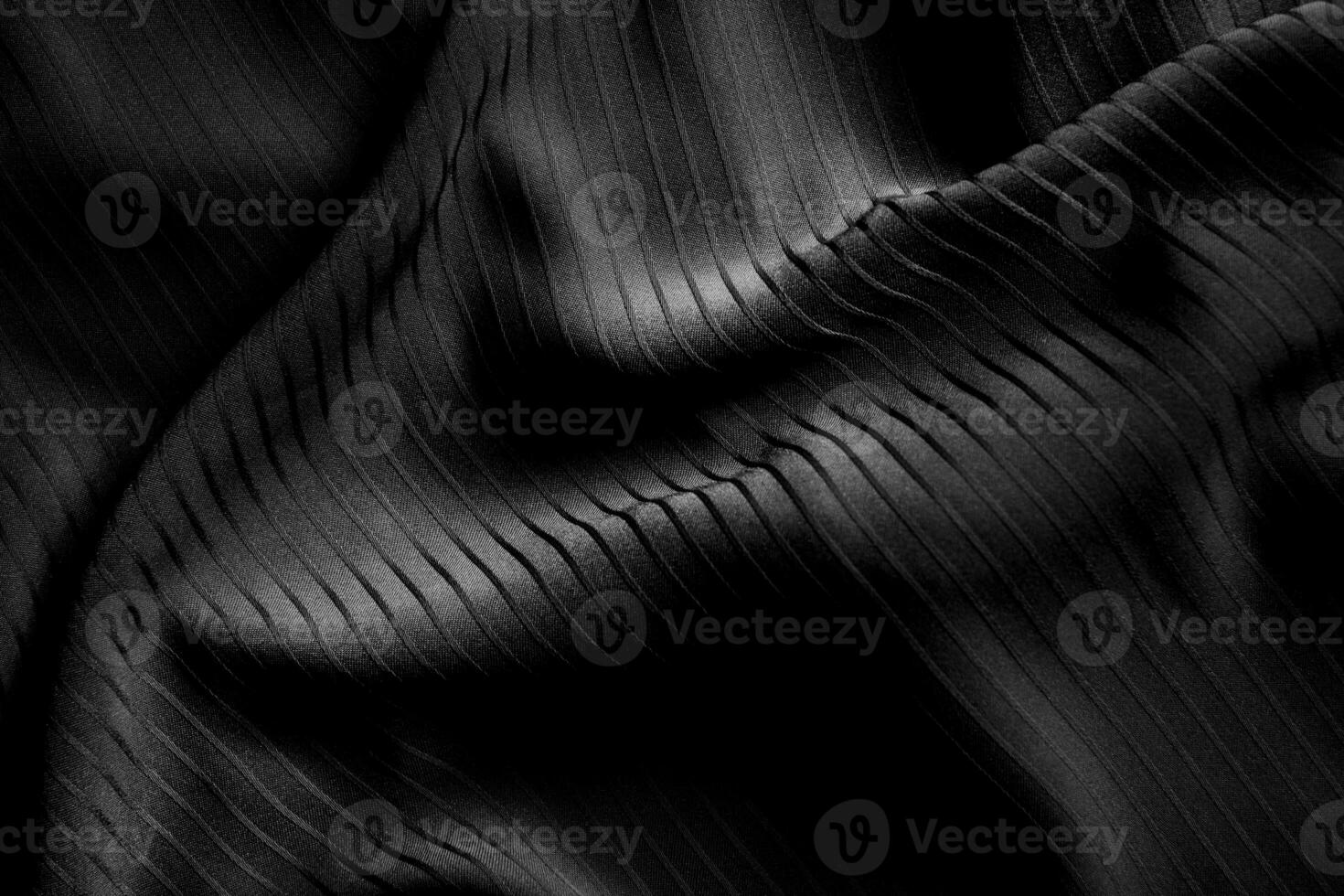 Dark black and gray blurred gradient and line of cloth or fabric background has a little abstract light. photo