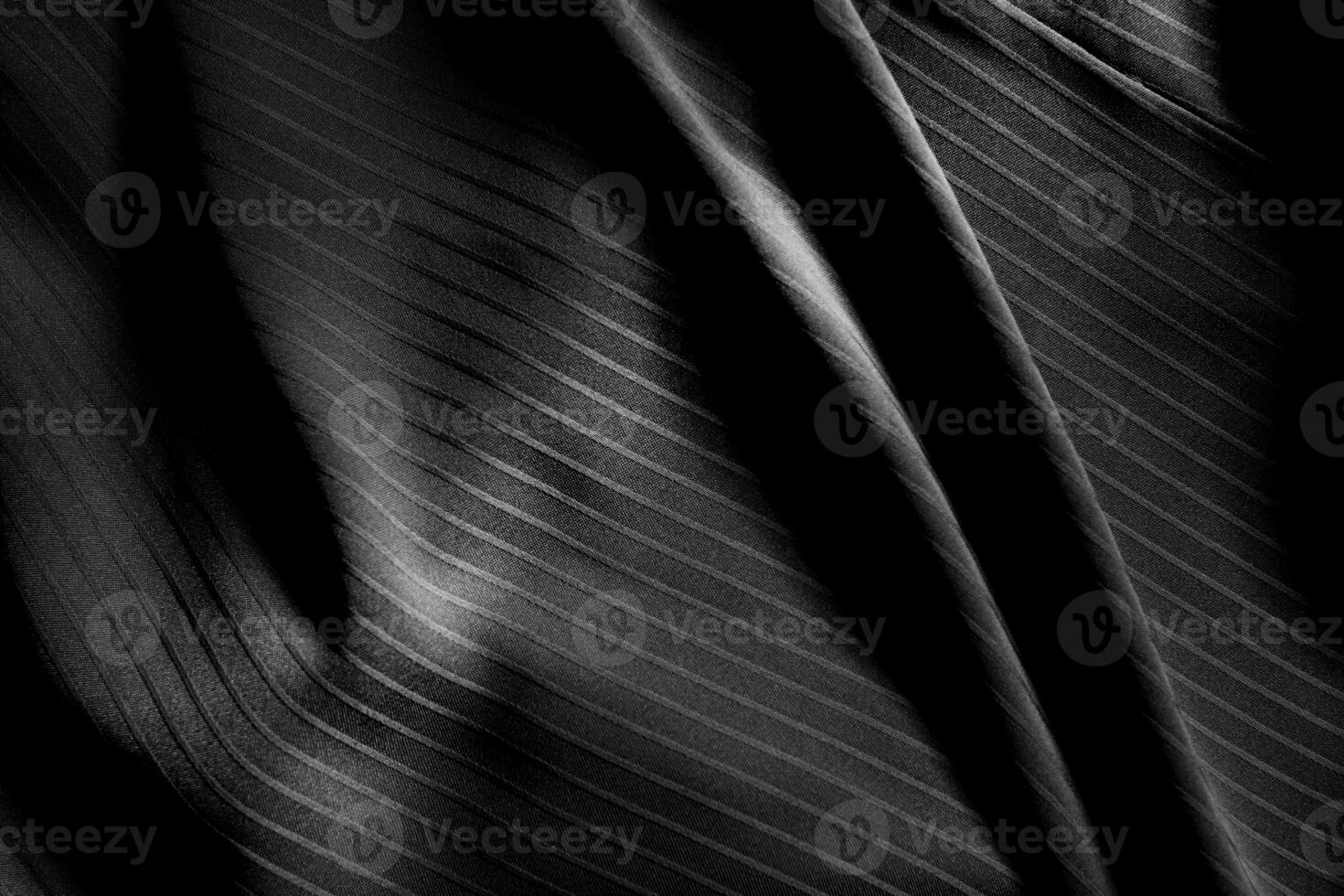 Dark black and gray blurred gradient and line of cloth or fabric background has a little abstract light. photo