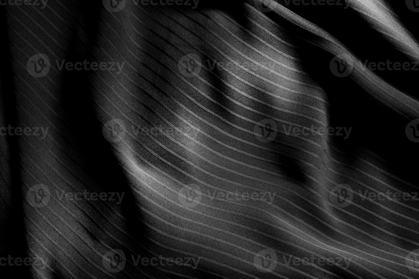 Dark black and gray blurred gradient and line of cloth or fabric background has a little abstract light. photo