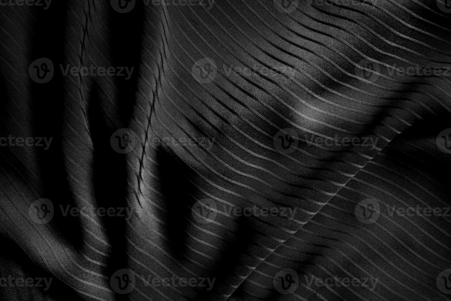 Dark black and gray blurred gradient and line of cloth or fabric background has a little abstract light. photo