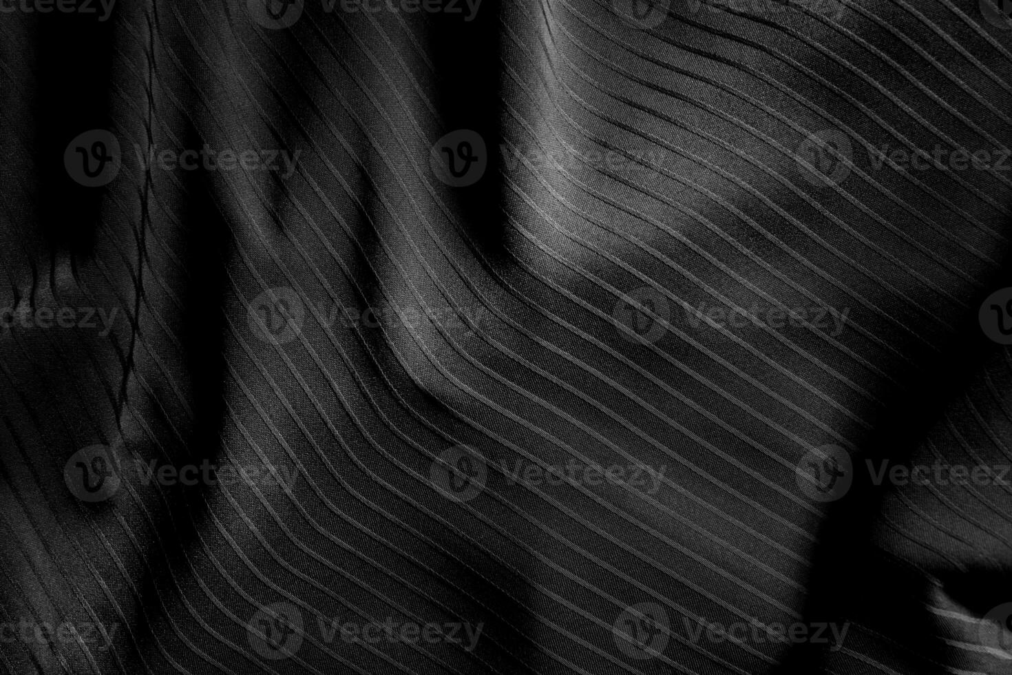 Dark black and gray blurred gradient and line of cloth or fabric background has a little abstract light. photo