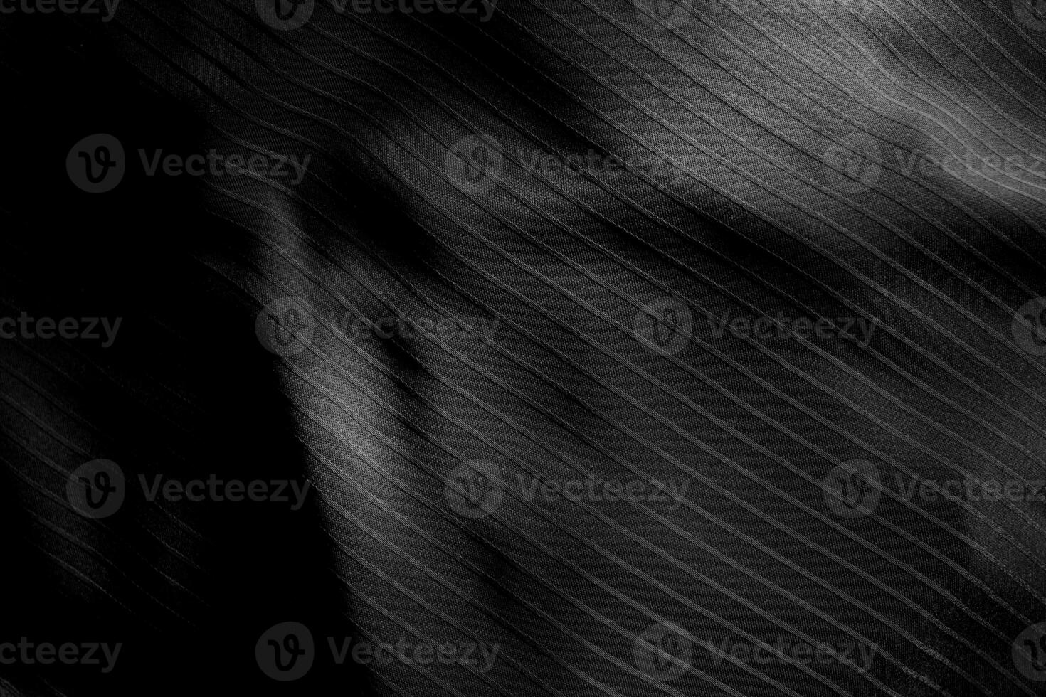 Dark black and gray blurred gradient and line of cloth or fabric background has a little abstract light. photo
