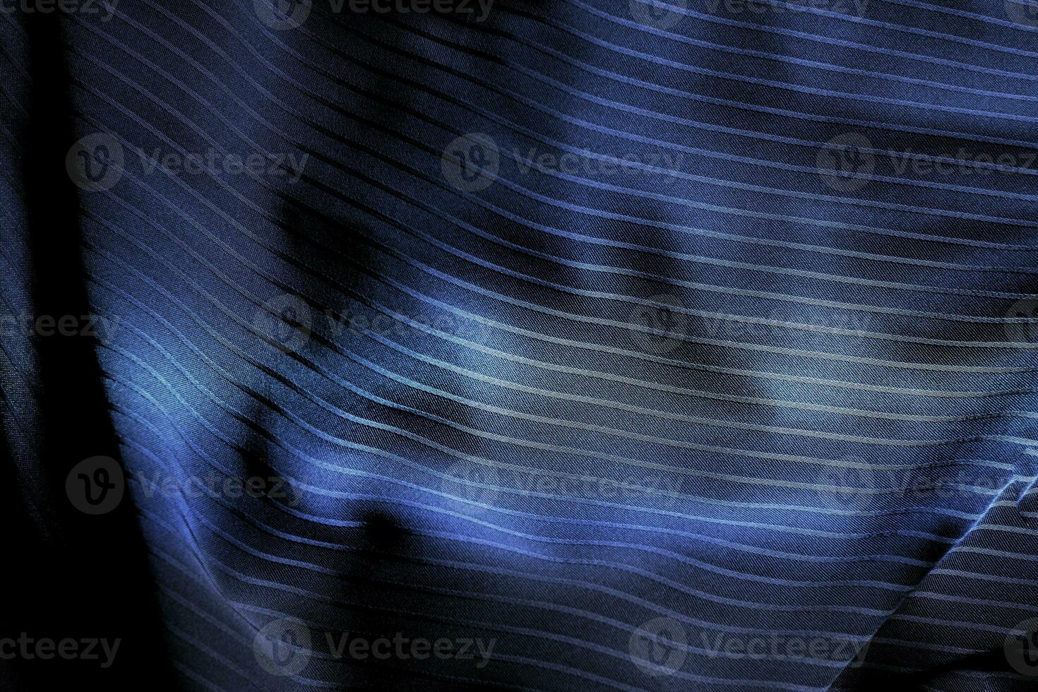 Dark black and gray blurred gradient and line of cloth or fabric background has a little abstract light. photo