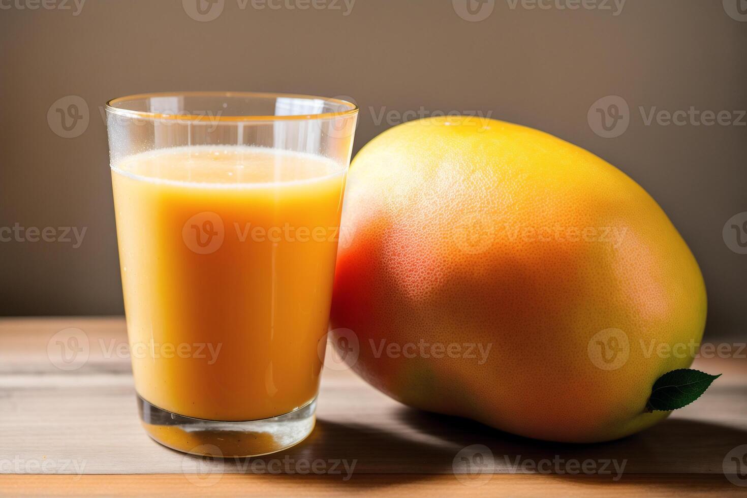 Glass of fresh mango juice on wooden table, closeup. Healthy food concept. photo