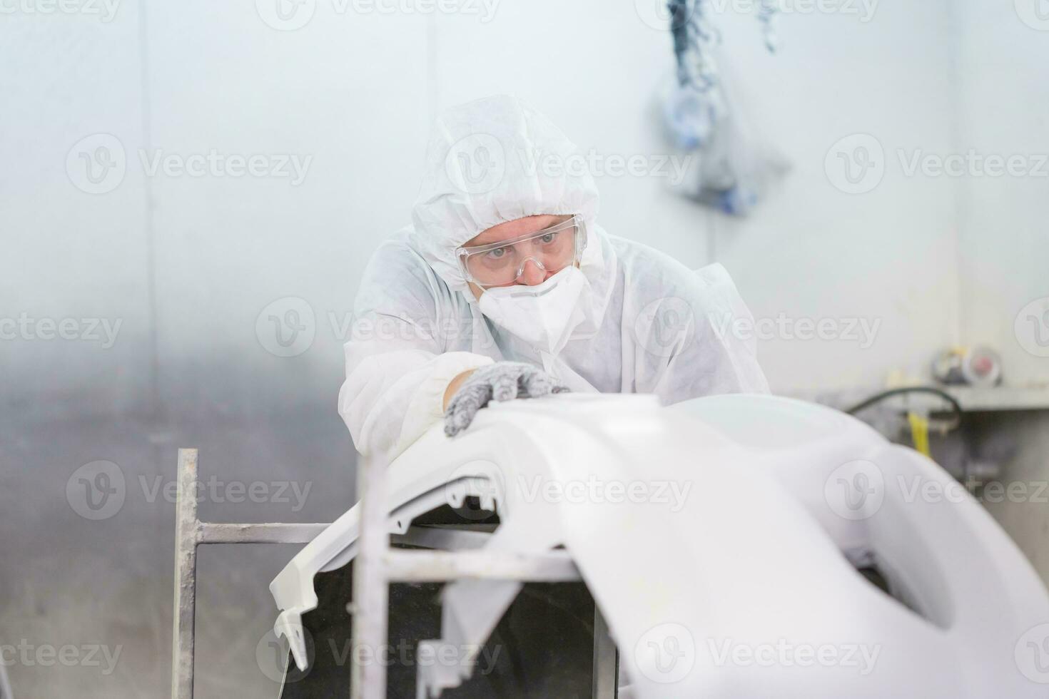 Mechanic man painting car in chamber, Technician checking the quality of the painting, Garage painting car service repair and maintenance photo