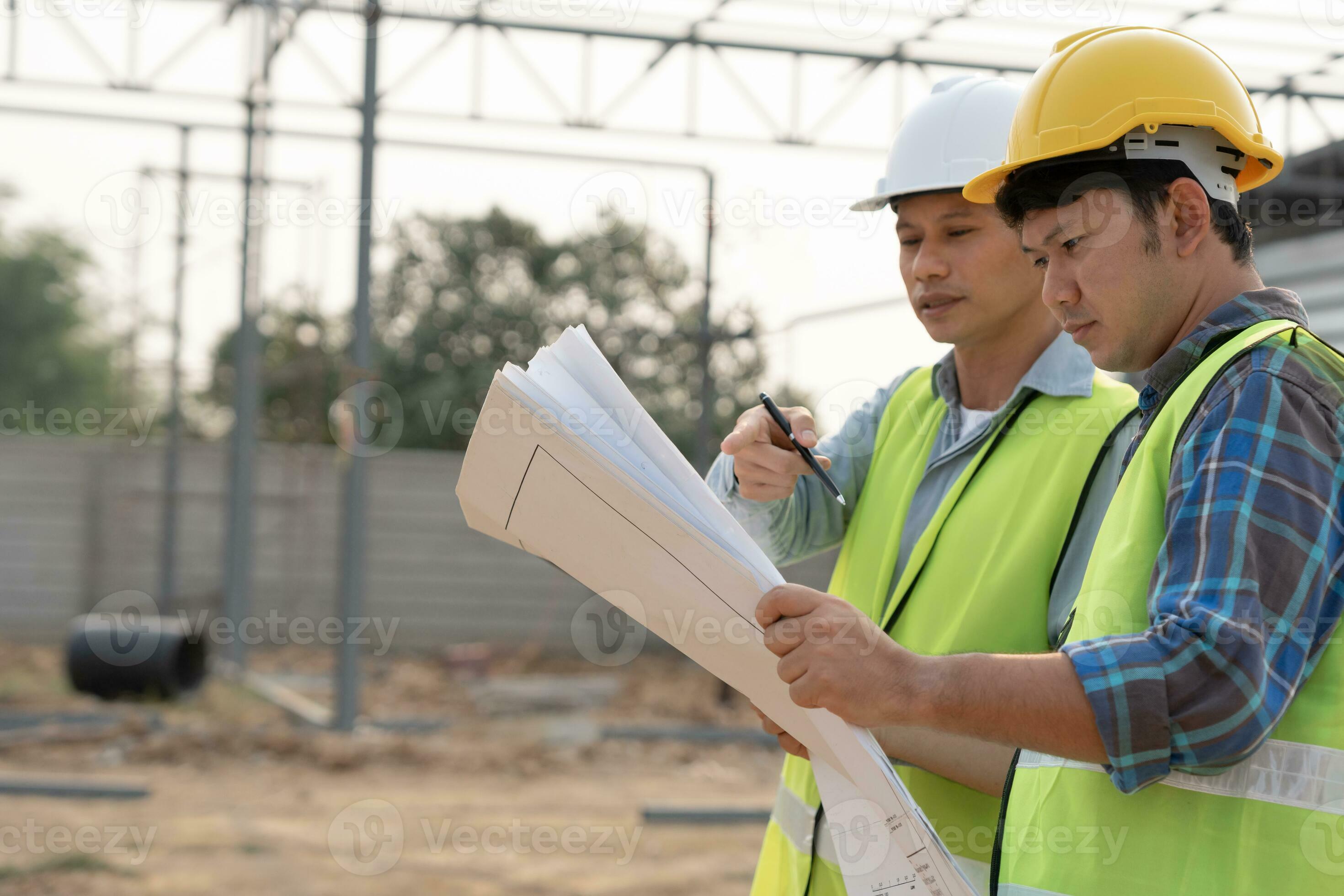 Engineers use blueprint check construction on site. Contractor and