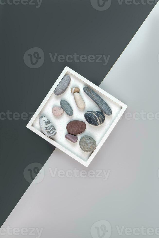 top view of square caramic tray with seasells on gray background. Interior decoration photo