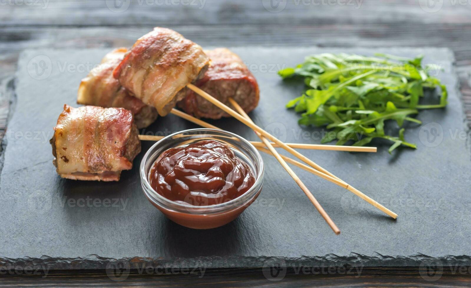 Bacon-wrapped beef skewers stuffed with mozzarella photo