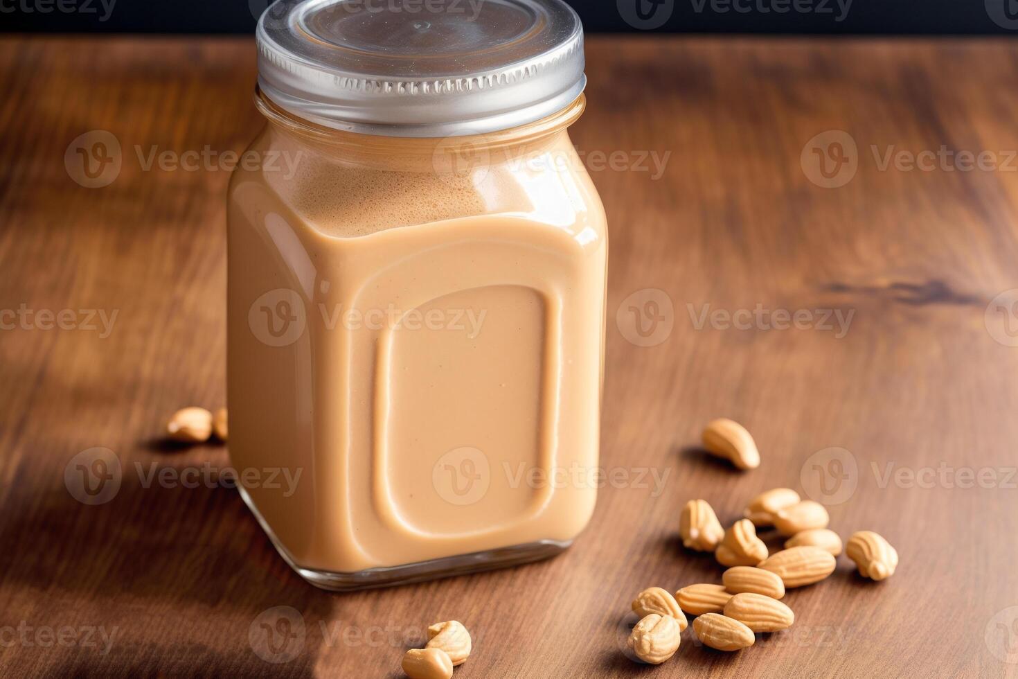 Peanut butter in a glass jar with peanuts on a wooden background. healthy food concept. photo