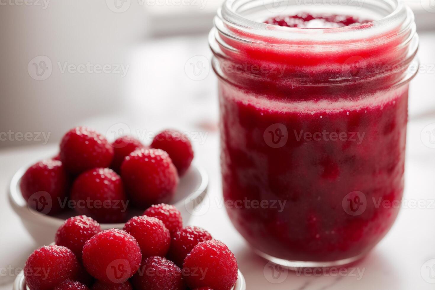 Raspberry jam in glass jars on a white background. Selective focus. photo