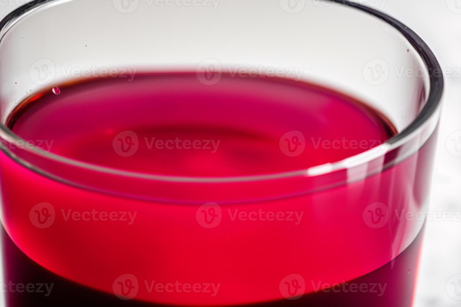 Cranberry juice in a glass on a wooden table, selective focus. Healthy food concept. photo