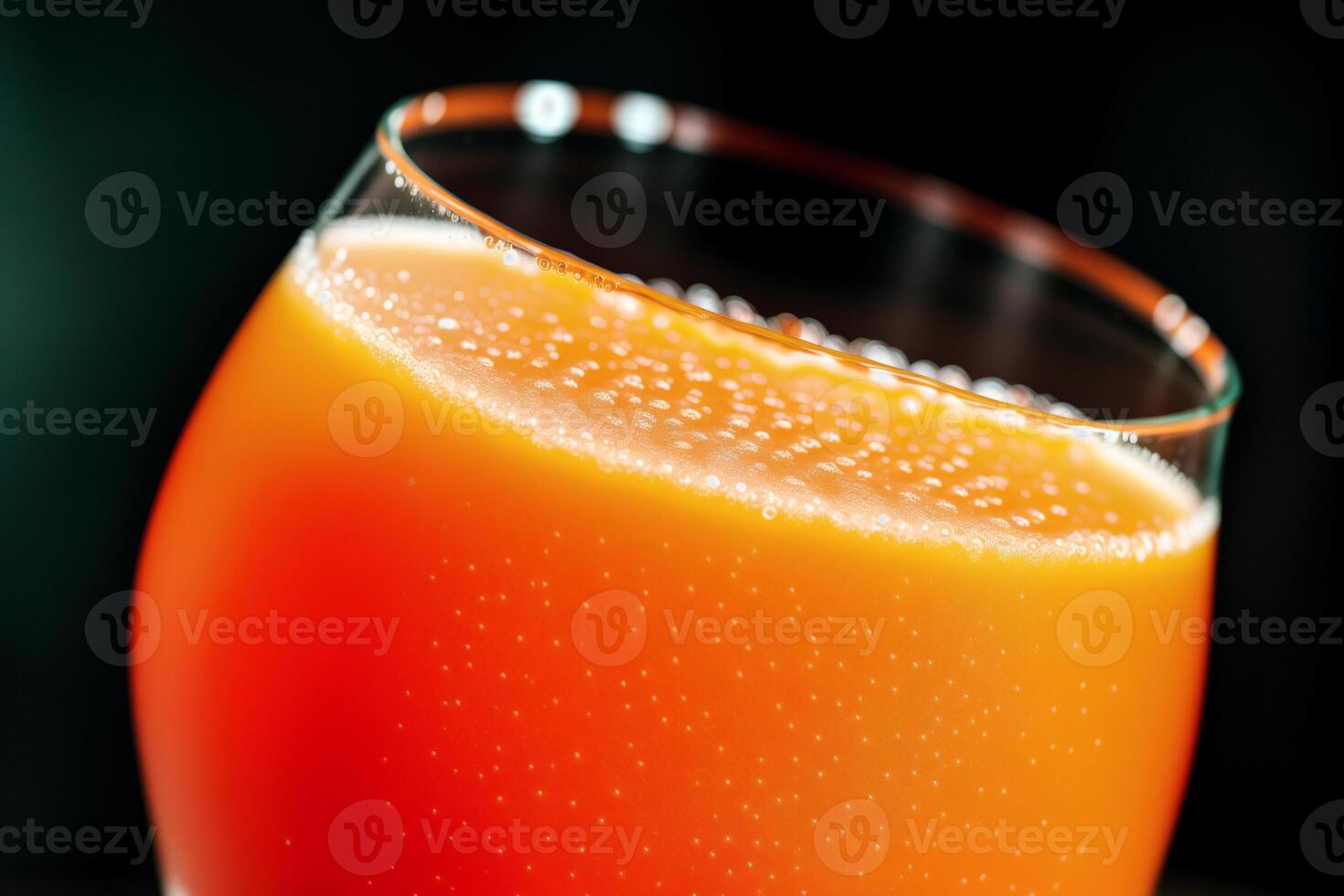 Carrot juice in a glass with fresh carrots on a dark background. close up. Healthy food concept. photo