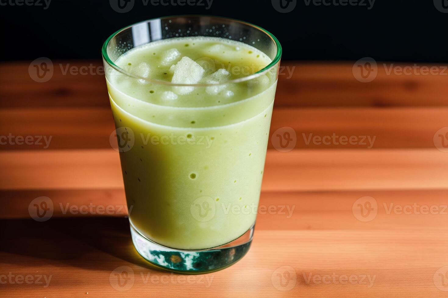 Cucumber smoothie in a glass on a black background. Green smoothie with lime and mint. Healthy food concept. photo