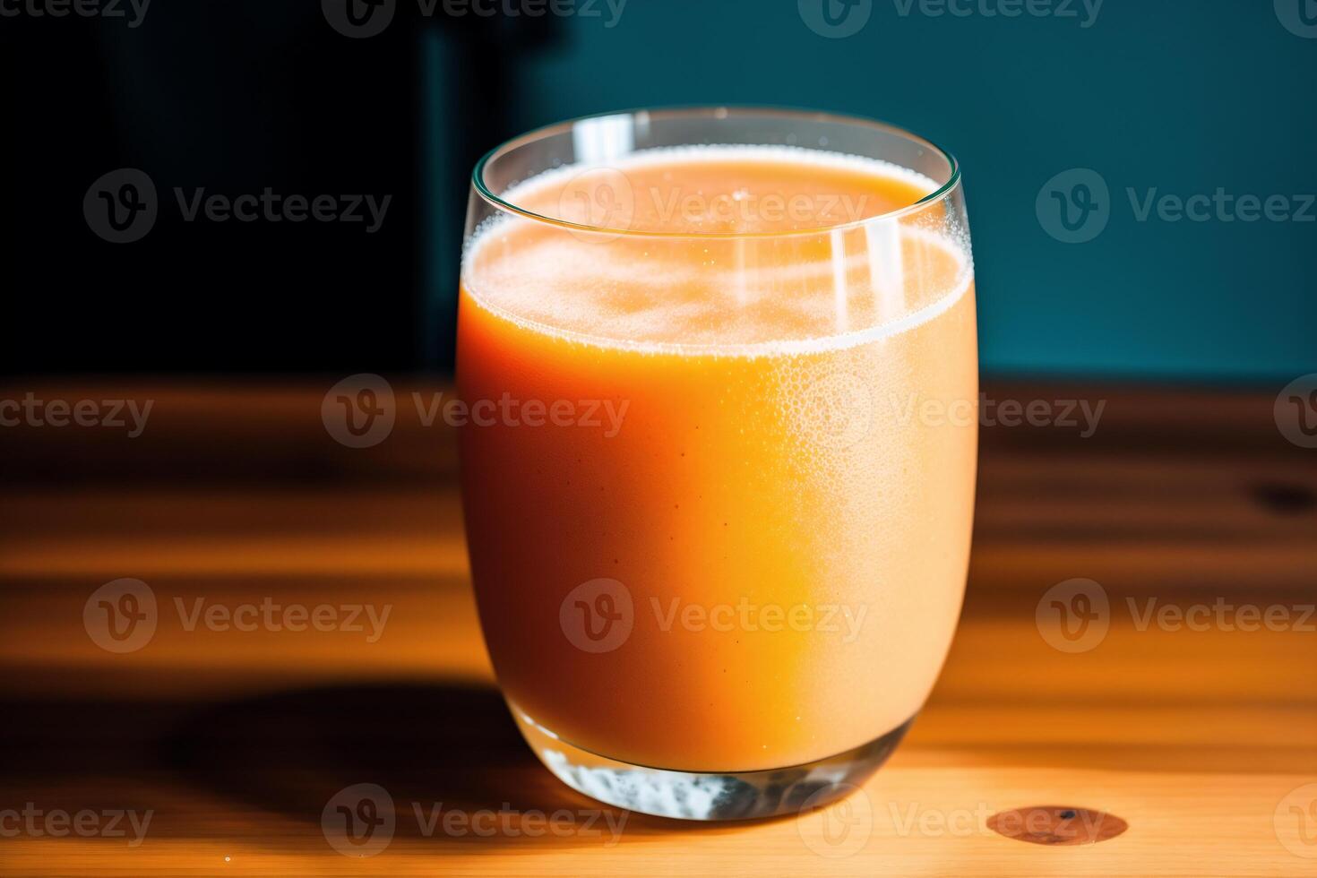 Glass of fresh mango juice on wooden table, closeup. Healthy food concept. photo