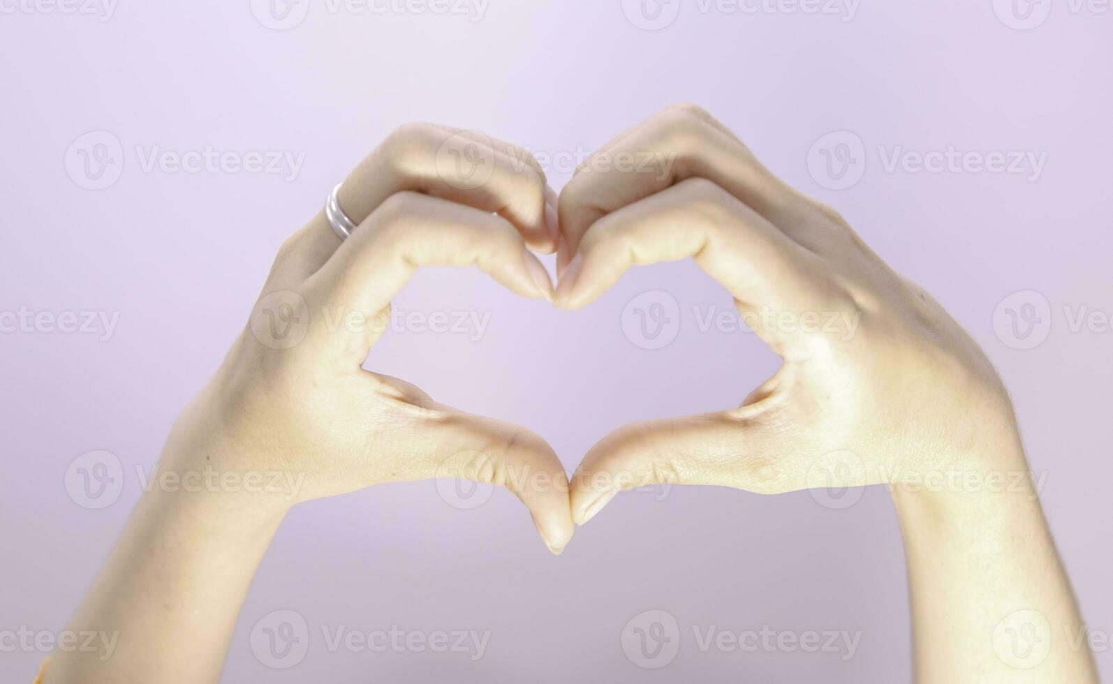 femalehand making a heart shape on isolated white background, beautiful woman's hand with copy space, valentine's day love concept photo