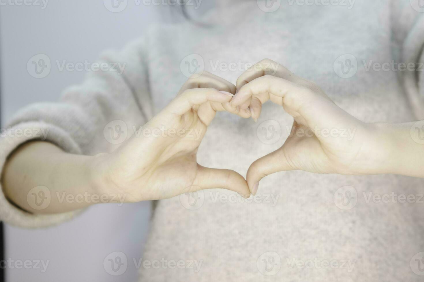 femalehand making a heart shape on isolated white background, beautiful woman's hand with copy space, valentine's day love concept photo