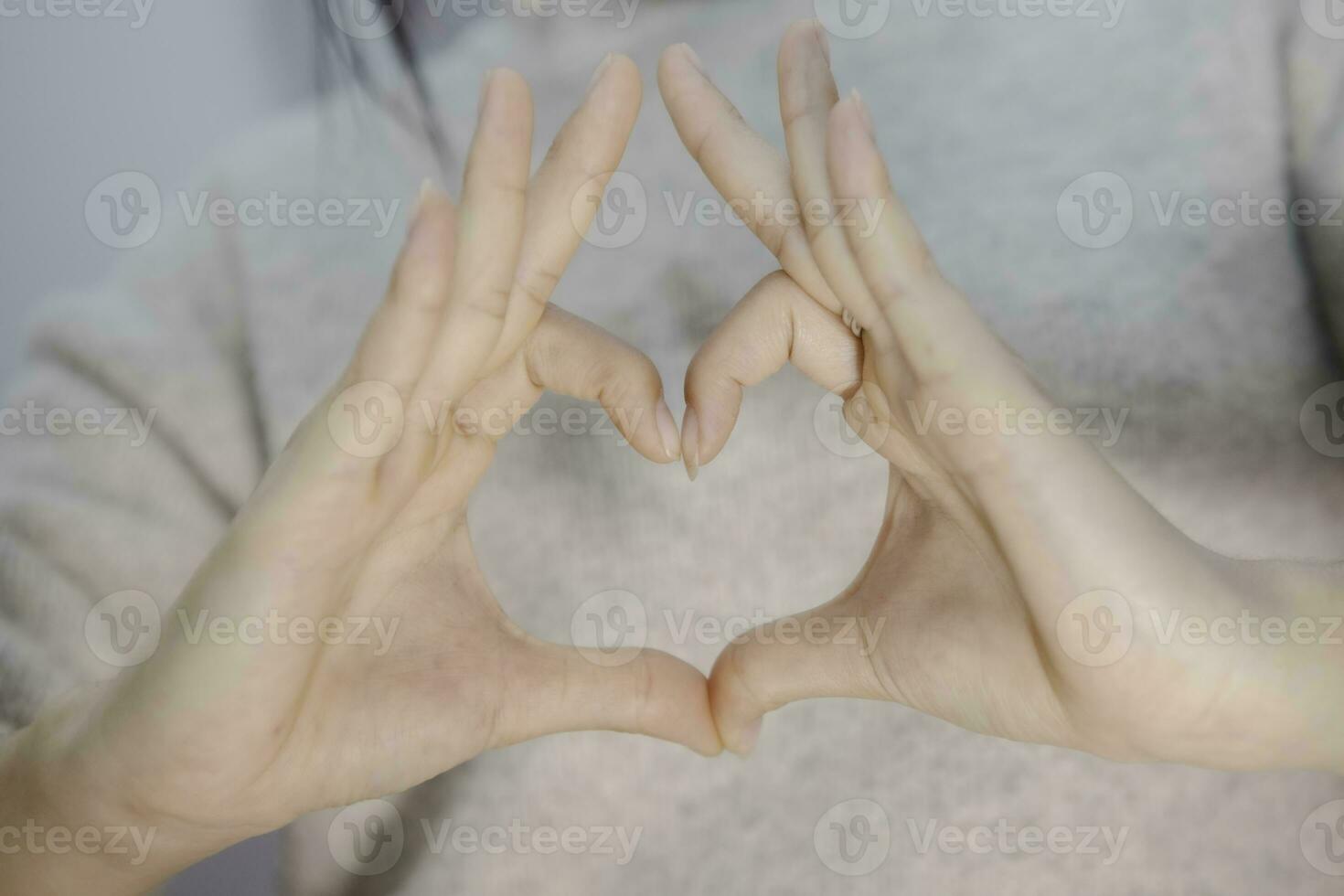 femalehand making a heart shape on isolated white background, beautiful woman's hand with copy space, valentine's day love concept photo