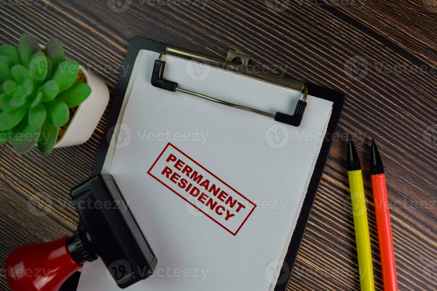 Red Handle Rubber Stamper and Permanent Residency text isolated on White Background. photo