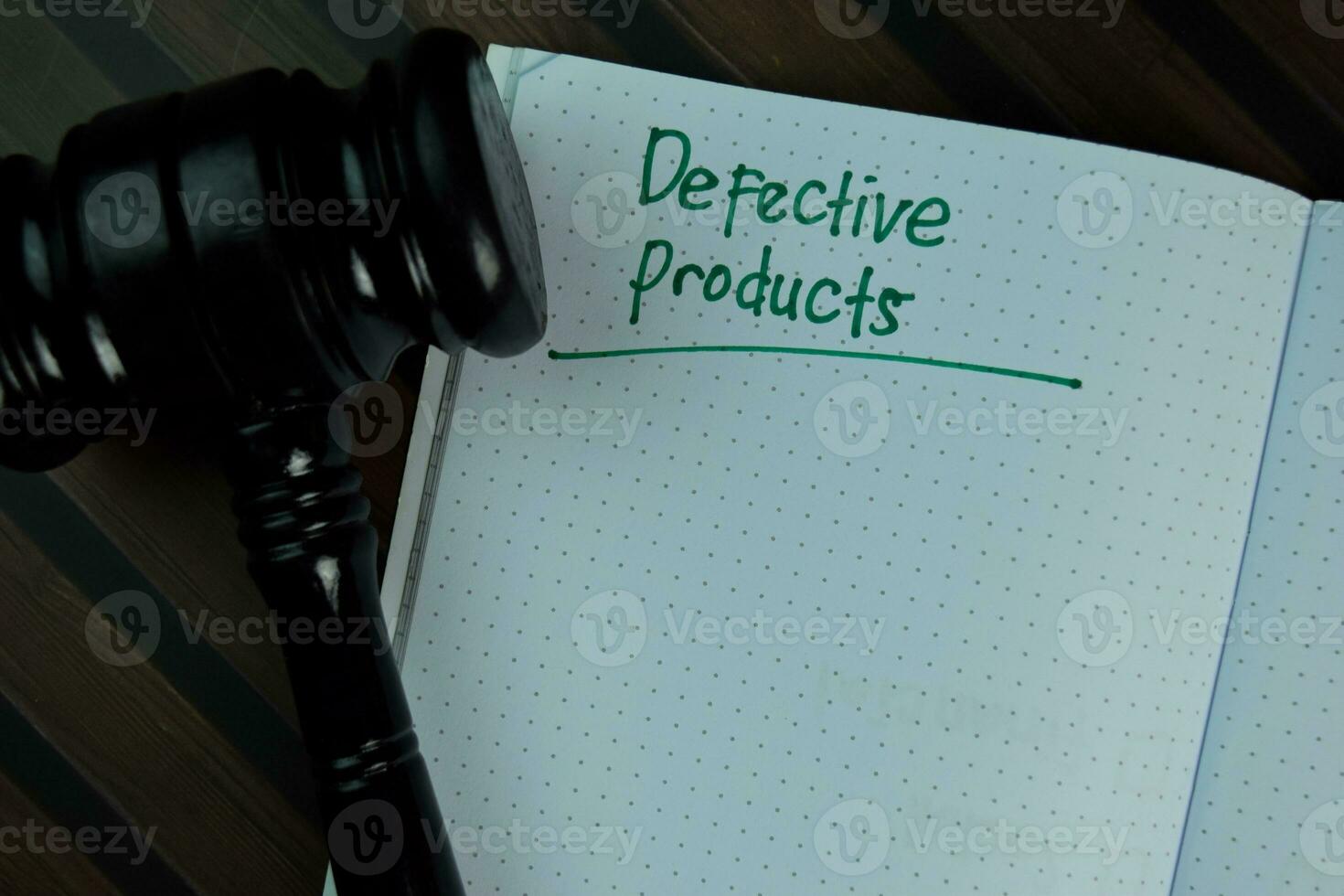 Defective Products write on a book isolated on Wooden Table. photo