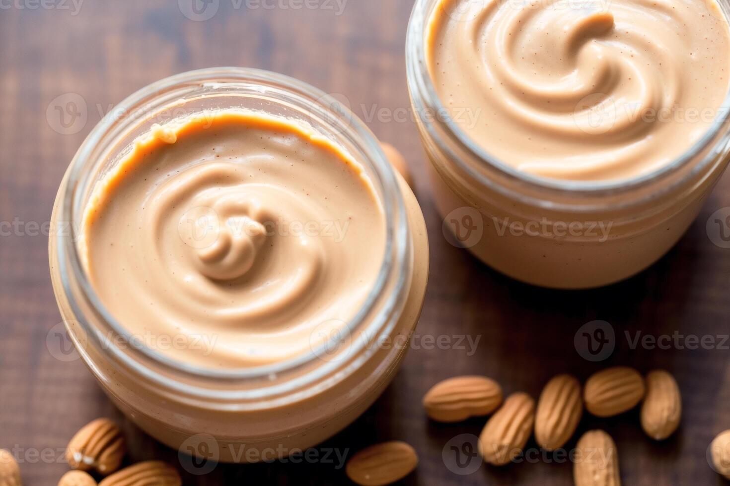 Peanut butter in a glass jar with peanuts on a wooden background. healthy food concept. photo