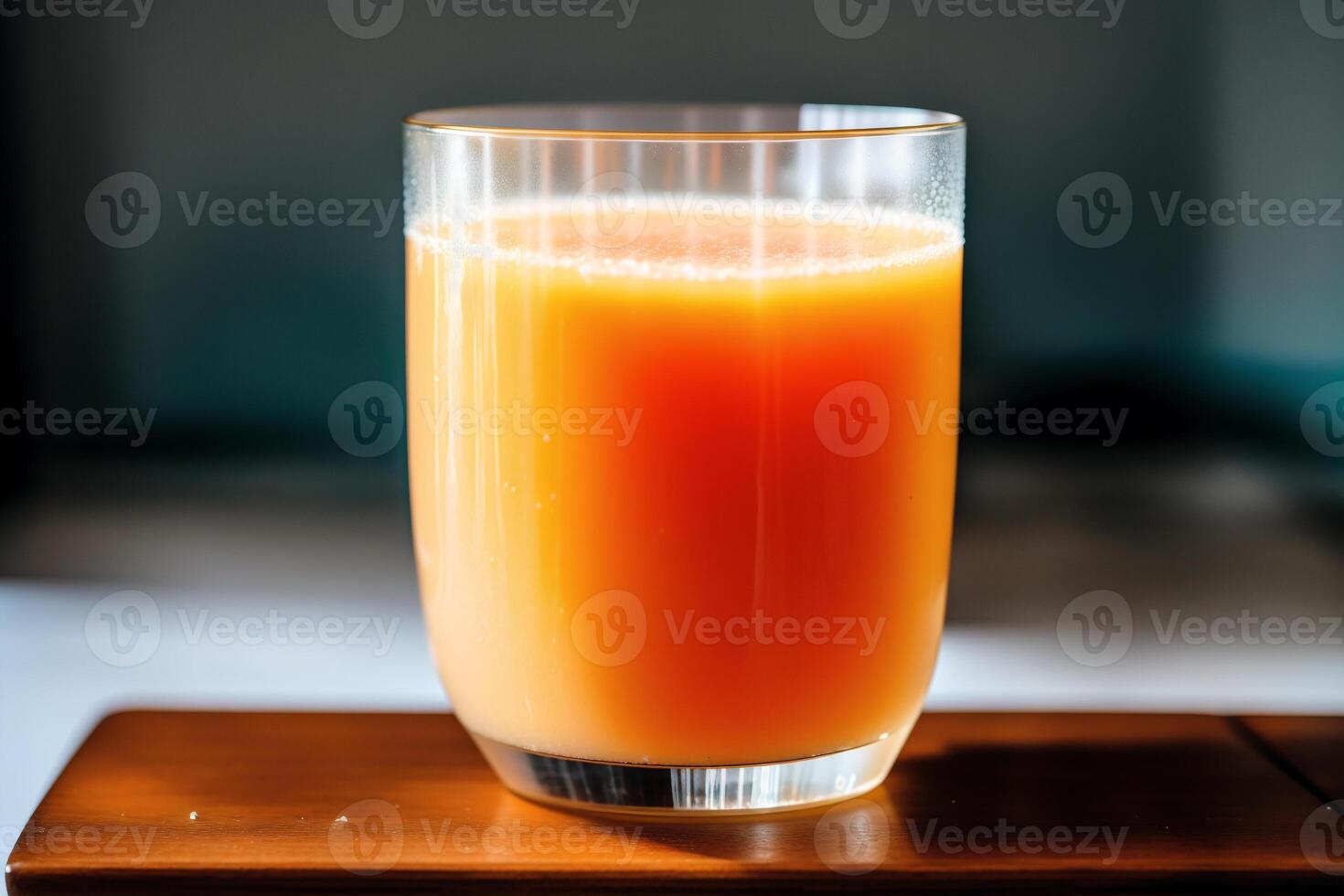 Glass of fresh mango juice on wooden table, closeup. Healthy food concept. photo