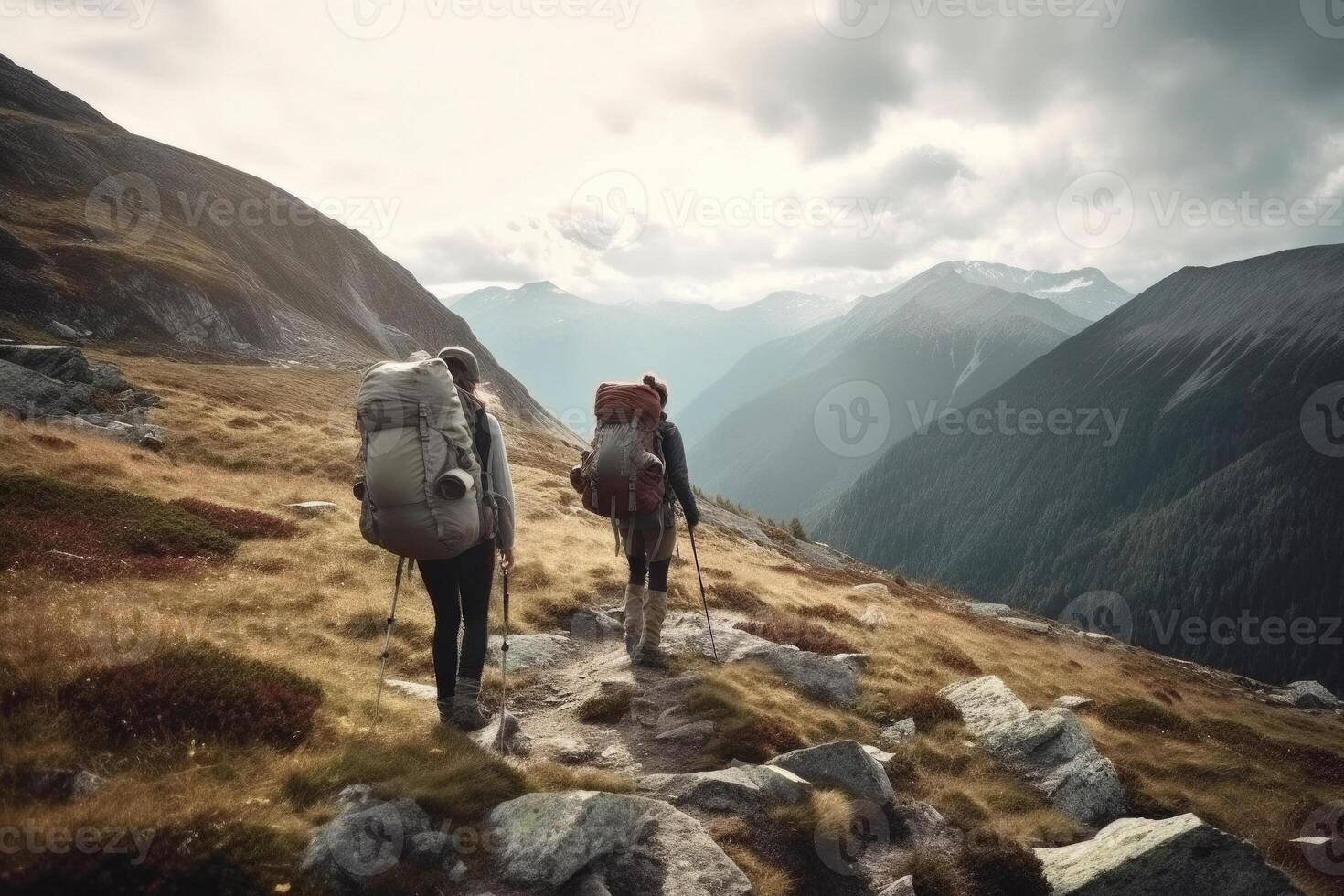 Travelers with backpacks hiking in mountains. photo