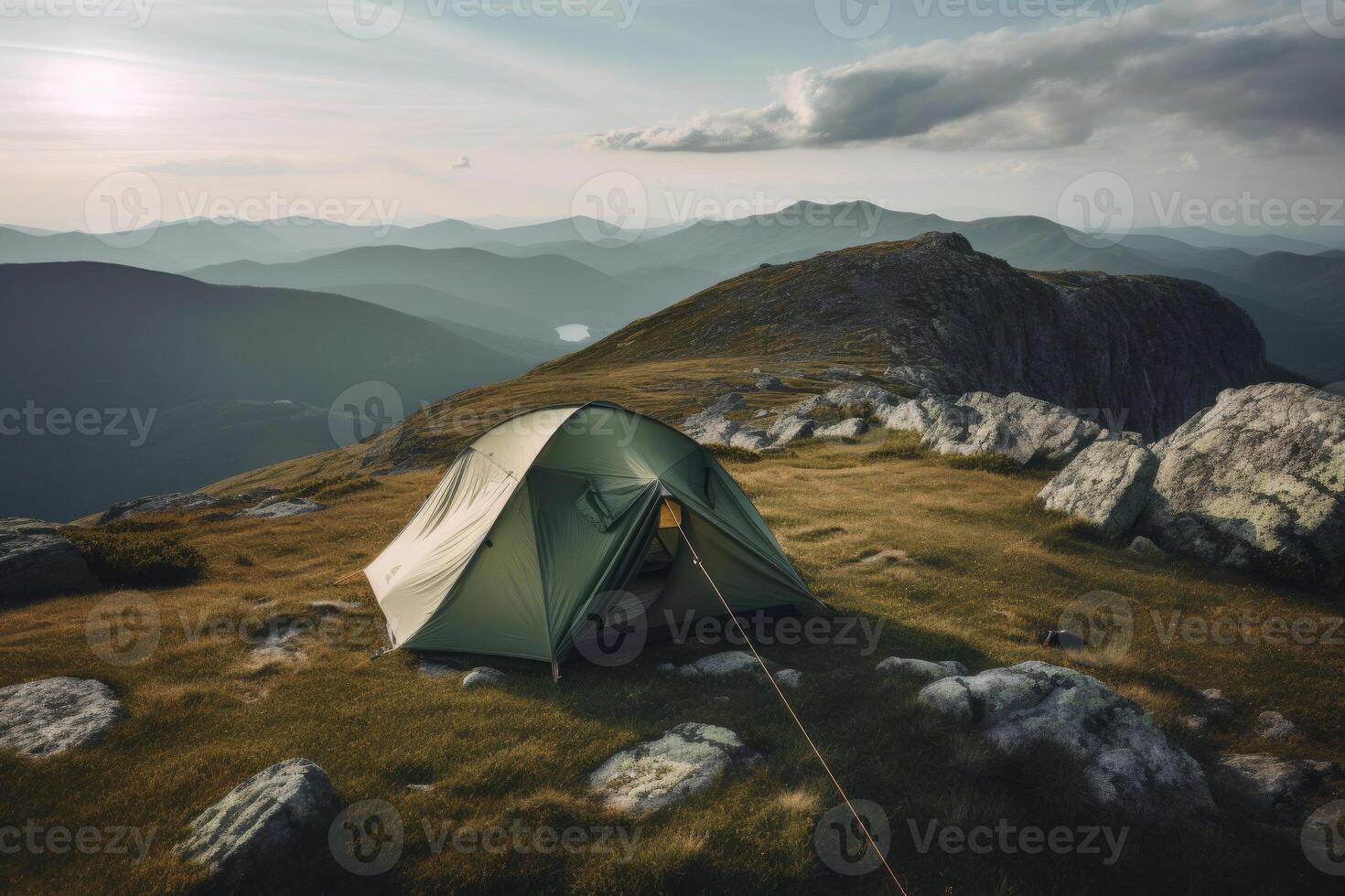 Camping tent with amazing view on mountain landscape at sunset. photo