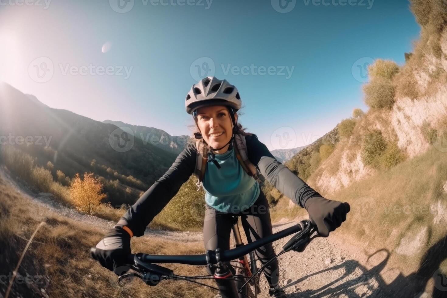 Professional cyclist in protective helmet trains on mountain road. photo