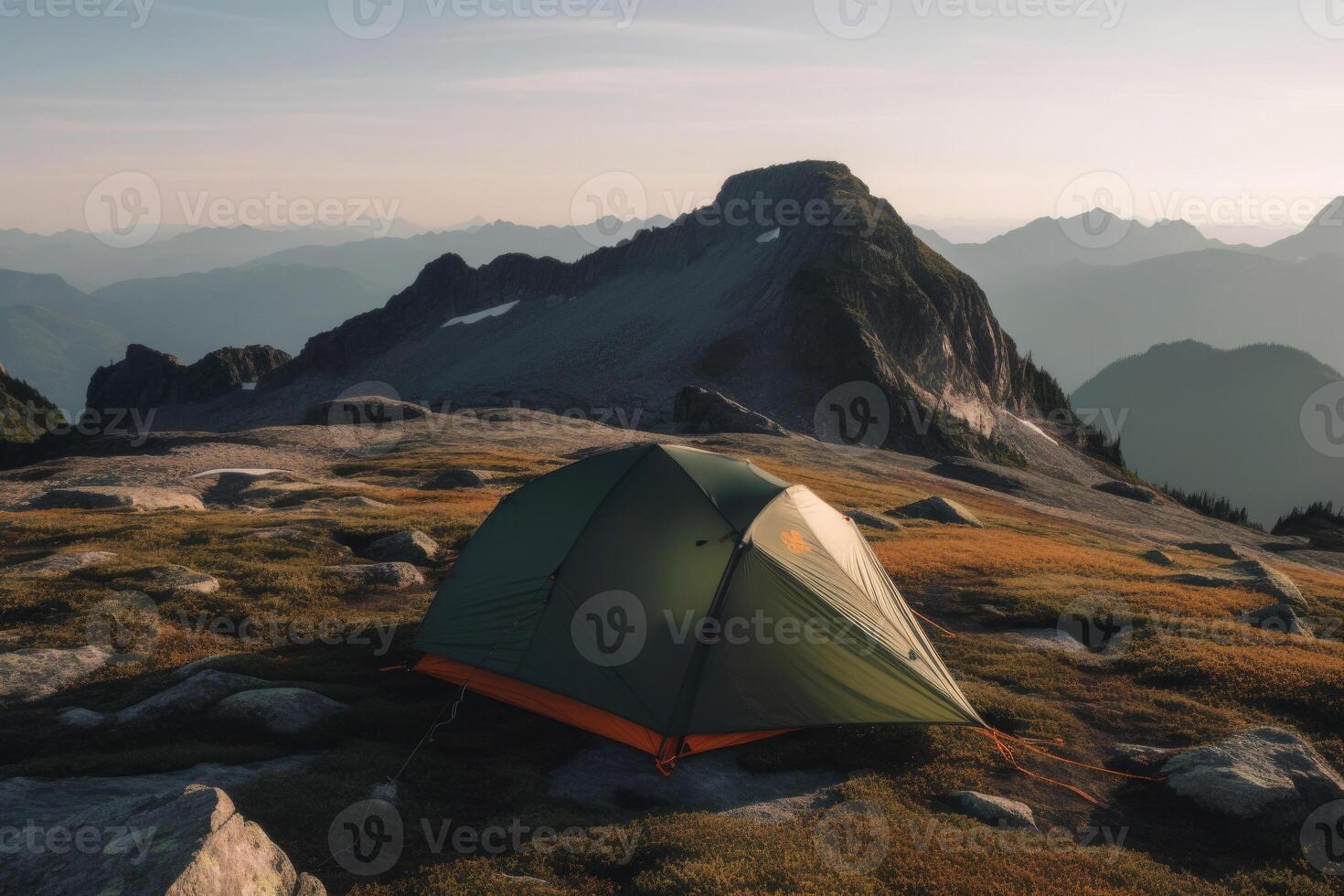 Camping tent with amazing view on mountain landscape at sunset. photo