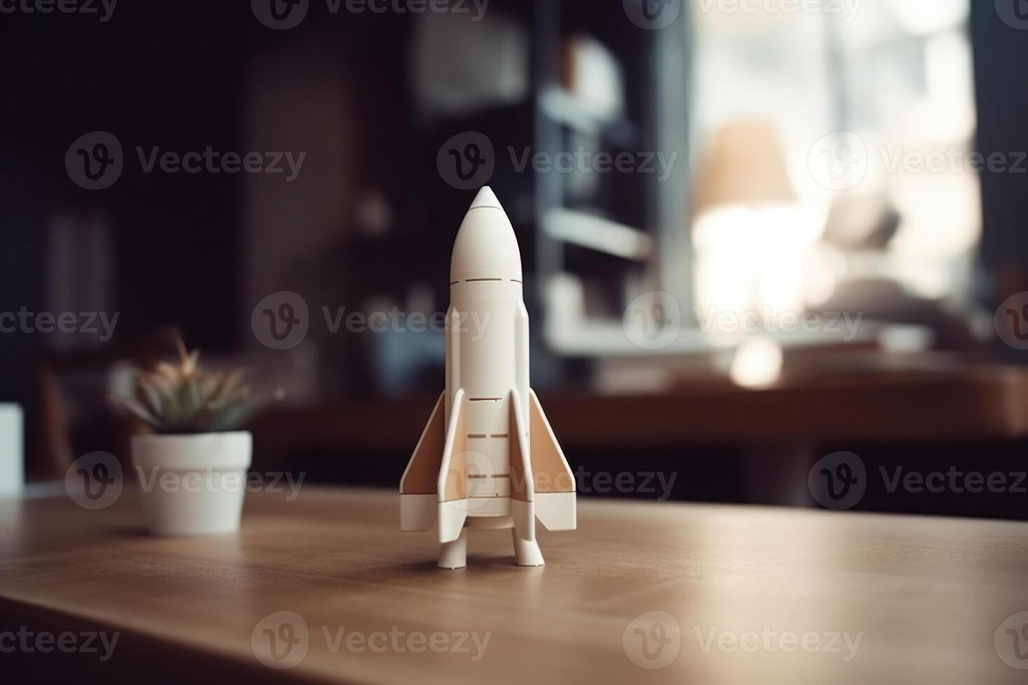 Successful startup concept. Launching rocket on office table. photo