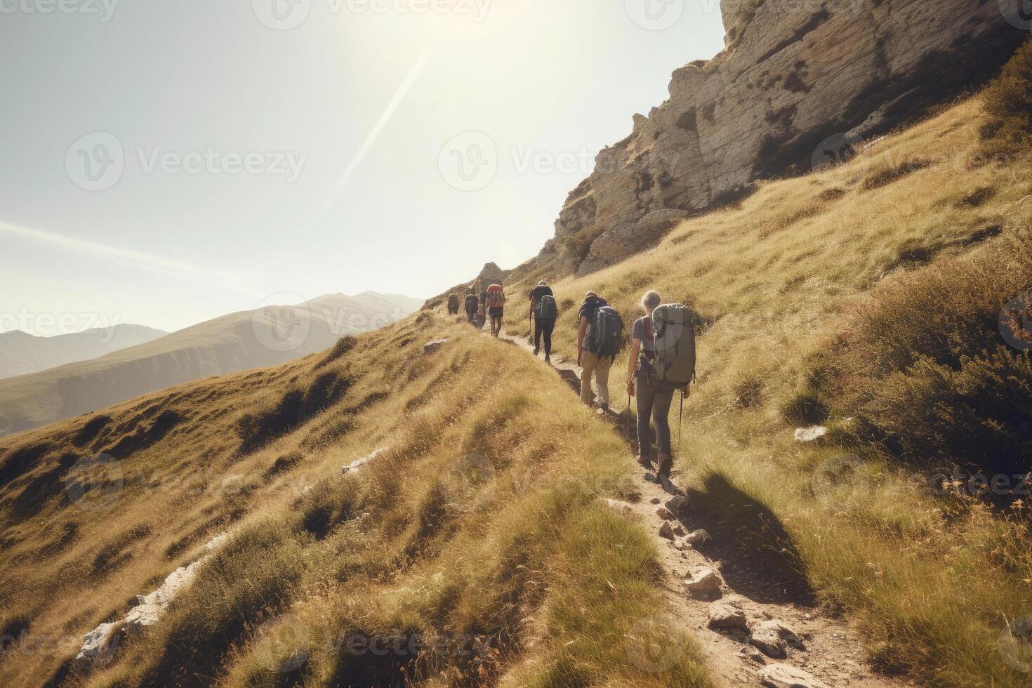 Travelers with backpacks hiking in mountains. photo