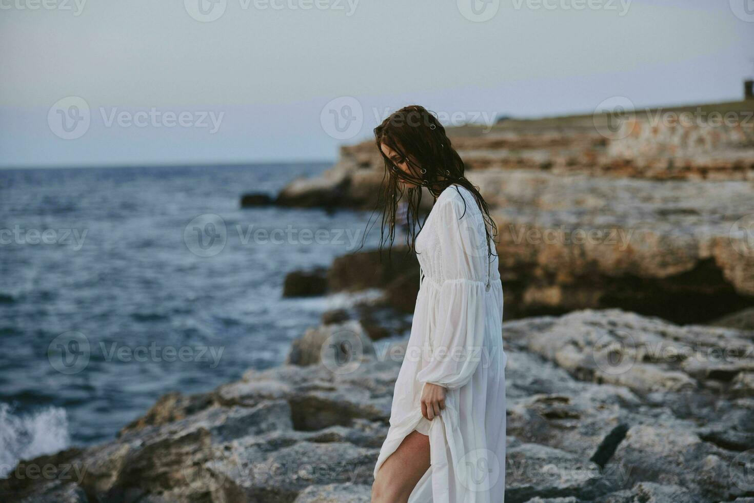 pretty woman in white dress landscape ocean side view unaltered photo
