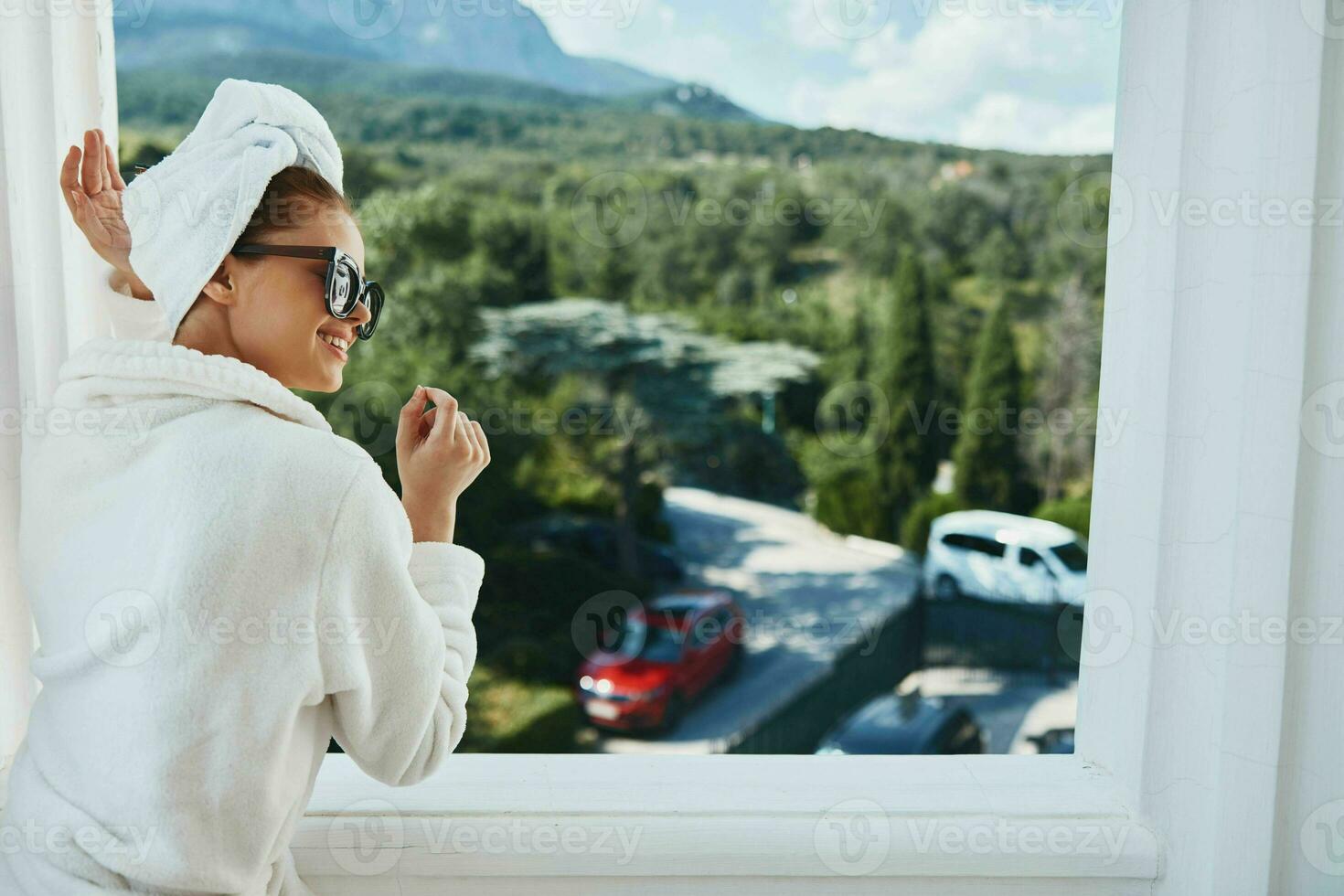 stylish woman posing against the backdrop of mountains on the balcony architecture unaltered photo
