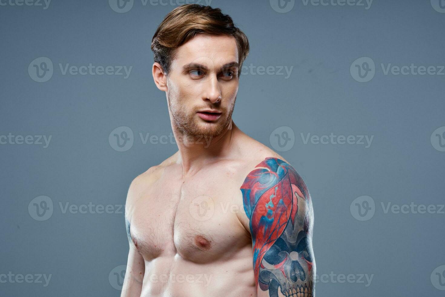 man with tattoo naked torso sport fitness gray background portrait photo