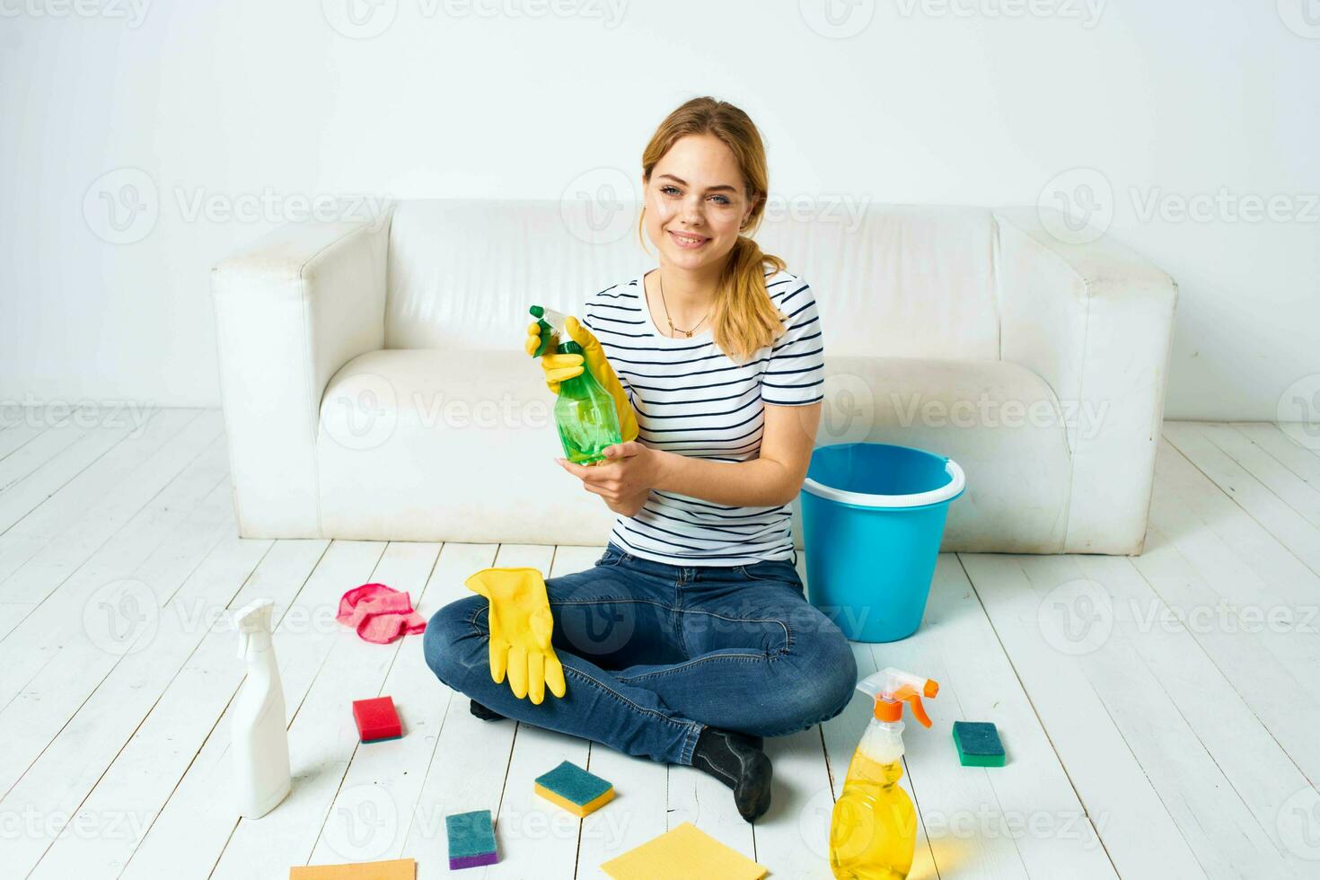 Woman sitting on the floor with cleaning supplies cleaning service housework photo