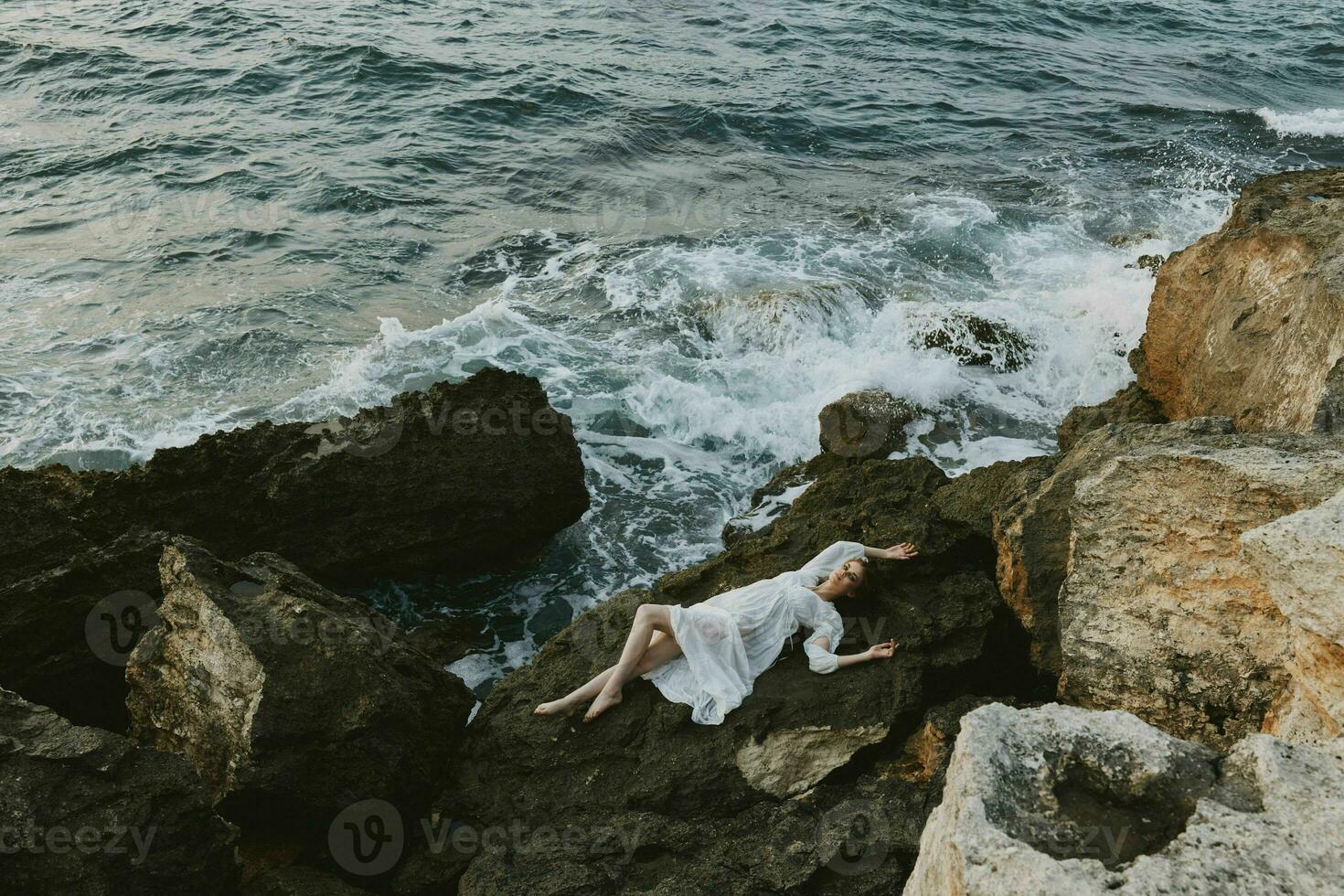 Beautiful bride in white wedding dress on sea shore wet hair vacation concept photo