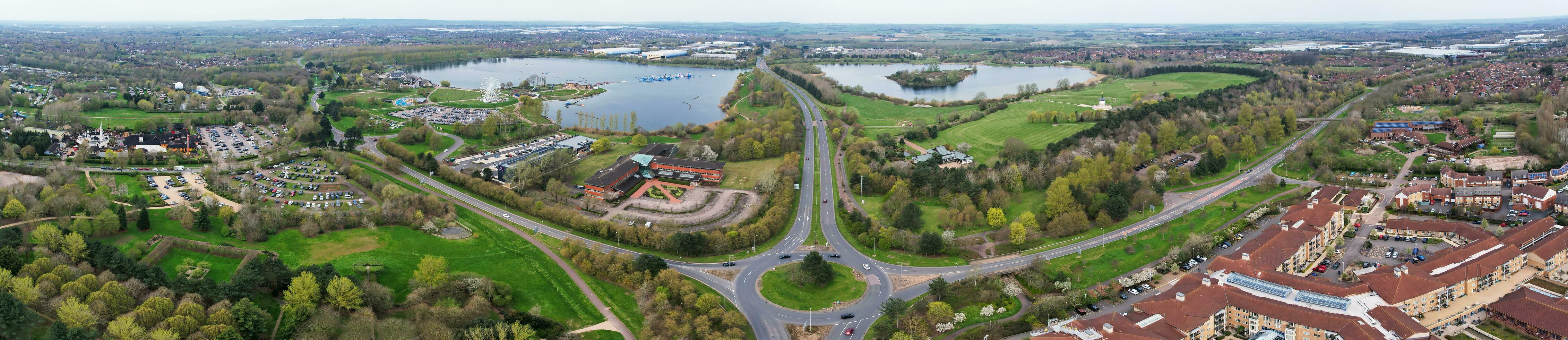 Low Angle View of Willen Lake Park with Local and Tourist Public Enjoying the Beauty of Lake and Park by Walking Around with Their Families. Footage Was Captured on 09-April-2023 at Milton Keynes UK photo