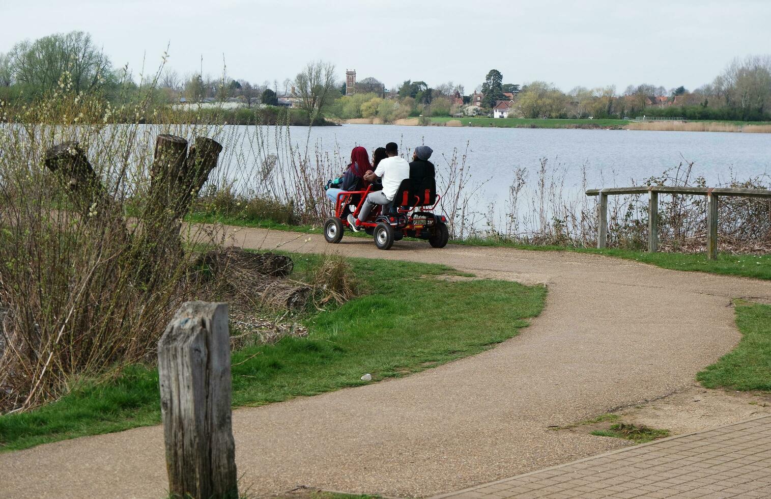 Low Angle View of Willen Lake Park with Local and Tourist Public Enjoying the Beauty of Lake and Park by Walking Around with Their Families. Footage Was Captured on 09-April-2023 at Milton Keynes UK photo