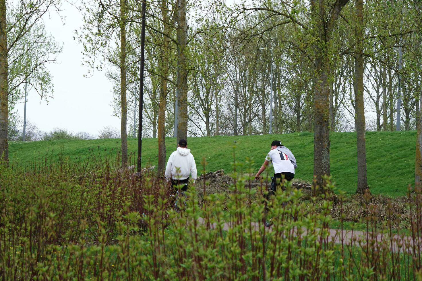 Low Angle View of Willen Lake Park with Local and Tourist Public Enjoying the Beauty of Lake and Park by Walking Around with Their Families. Footage Was Captured on 09-April-2023 at Milton Keynes UK photo