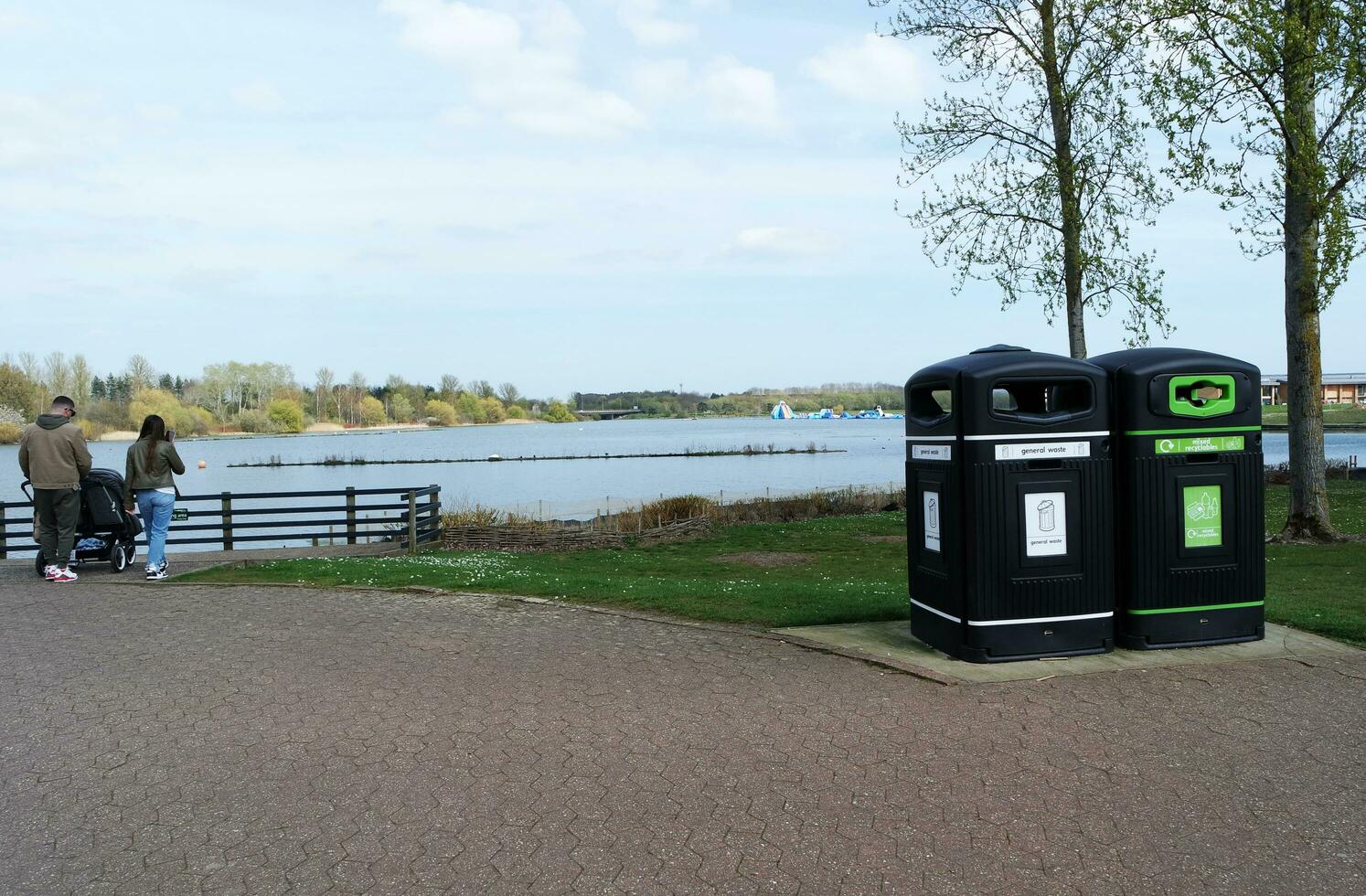 Low Angle View of Willen Lake Park with Local and Tourist Public Enjoying the Beauty of Lake and Park by Walking Around with Their Families. Footage Was Captured on 09-April-2023 at Milton Keynes UK photo