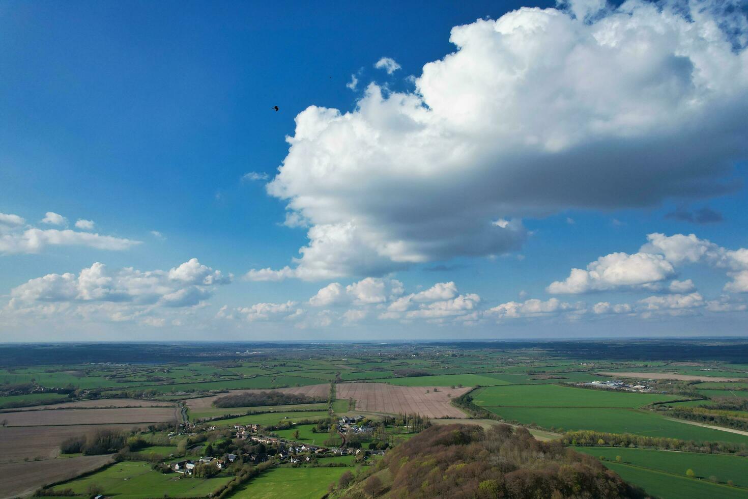 Aerial View of British Countryside and Paragliders while they are Flying High in the Sky. Drone's Camera Footage. photo