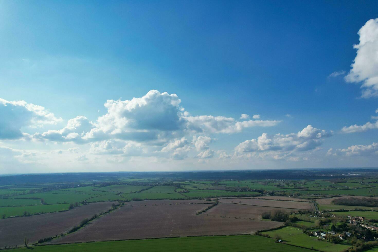 Aerial View of British Countryside and Paragliders while they are Flying High in the Sky. Drone's Camera Footage. photo