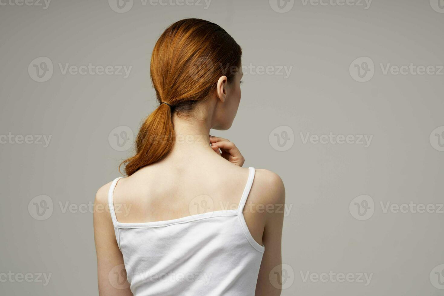 woman rheumatism pain in the neck health problems light background photo