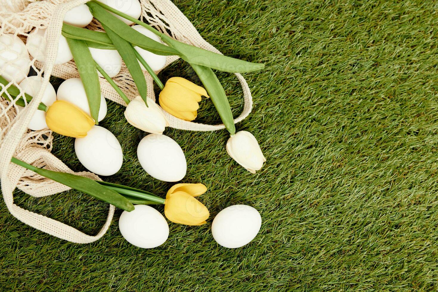 easter eggs flowers decoration in holiday tradition grass on background photo