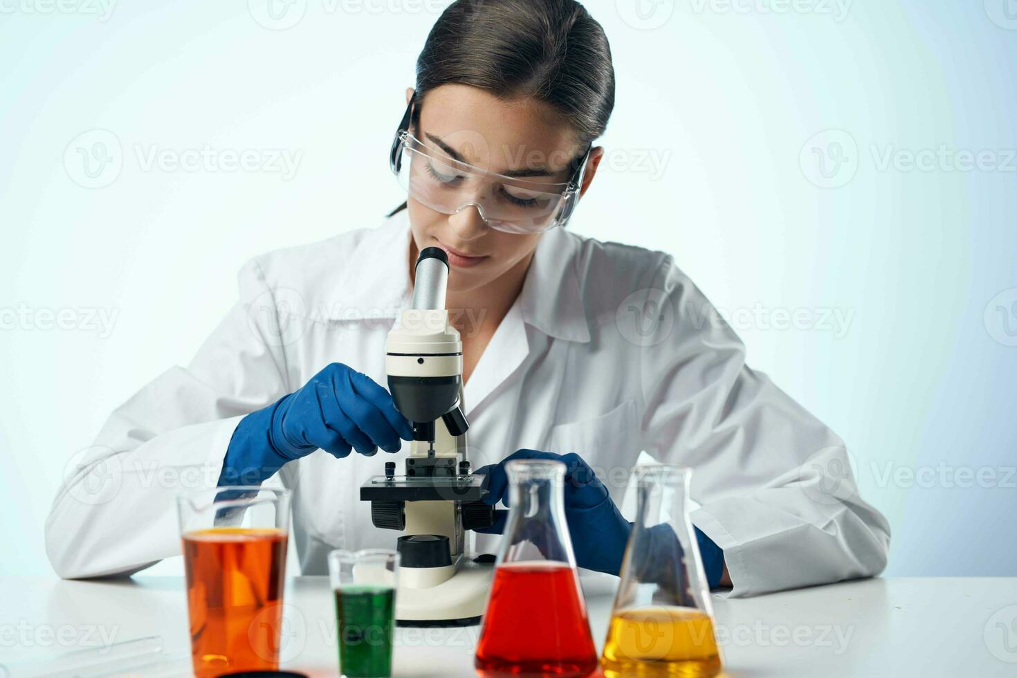 laboratory assistant in a white coat work table microscope diagnostics biotechnology photo